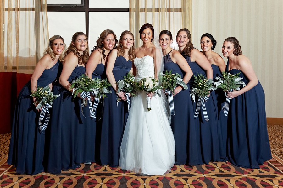 The bridesmaids word navy blue dresses by Alfred Angelo.